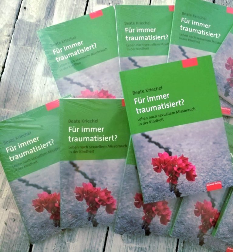 Mehrere arrangierte grüne Buchcover. Titel des Buches „Für immer traumatsiert?“ und piken Blumen, die aus Asphalt wachsen.